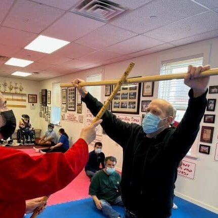 Man practicing martial arts with instructor.