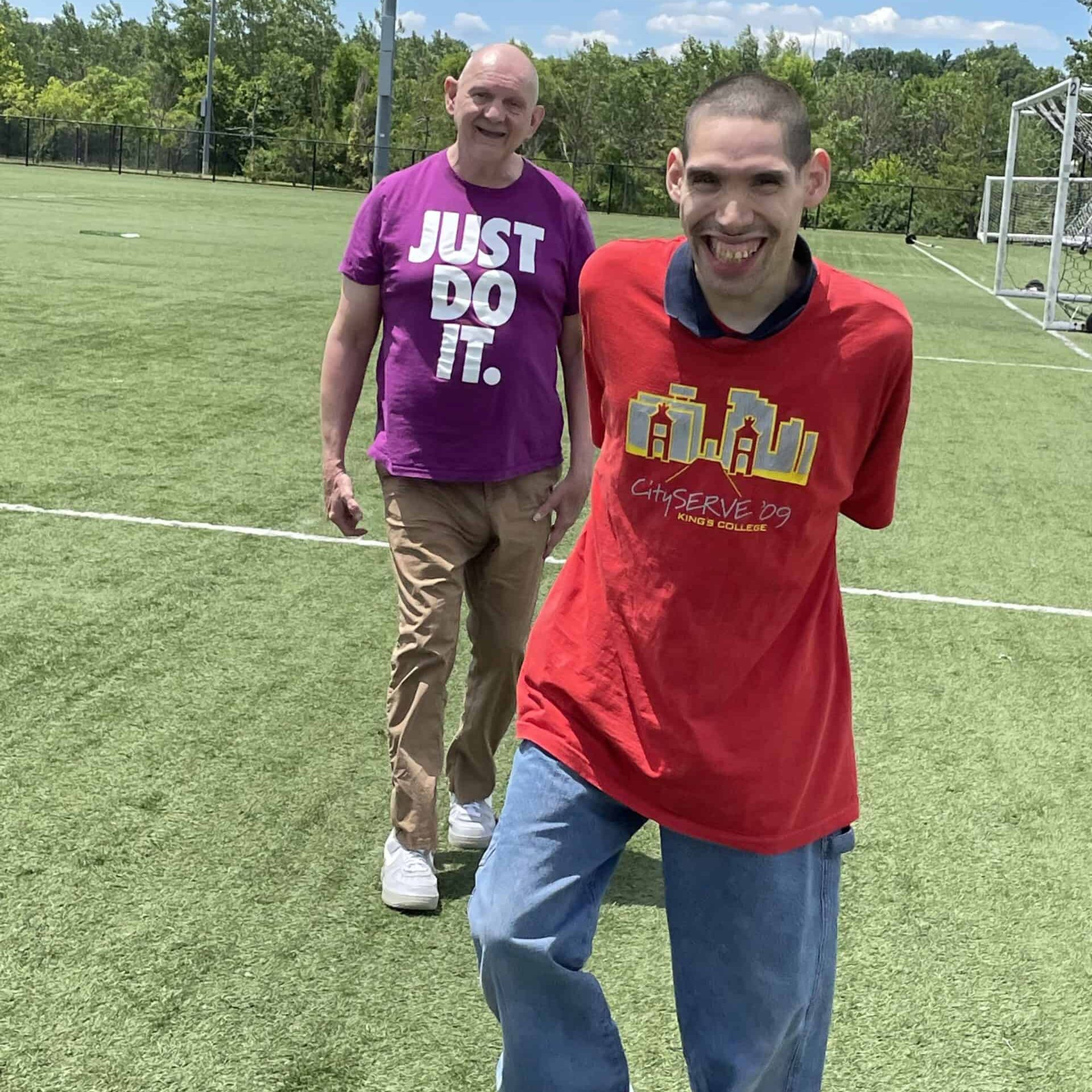 Two intellectually and developmentally disabled men enjoying a day in the park.