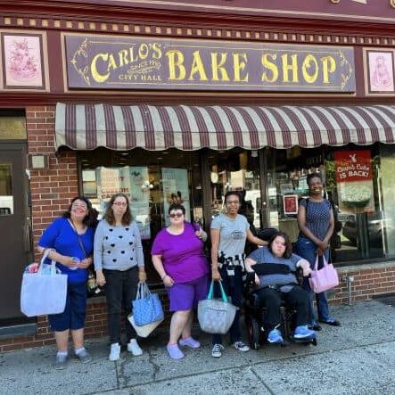 Ladies standing in front of Carlo's Bake Shop.